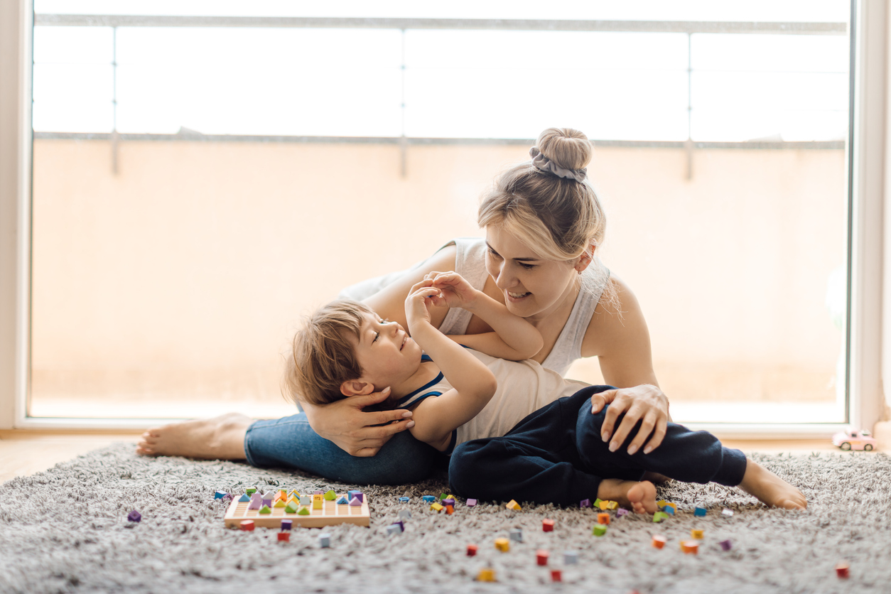 Mom plays with child on floor