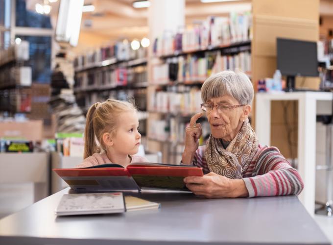 Old woman and girl in library