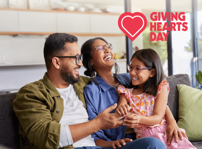 Family sitting on the couch laughing
