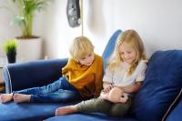 boy and girl looking at doll wondering proper names for their body parts