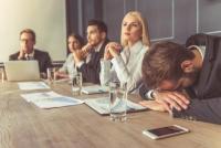 coworkers in a meeting looking bored